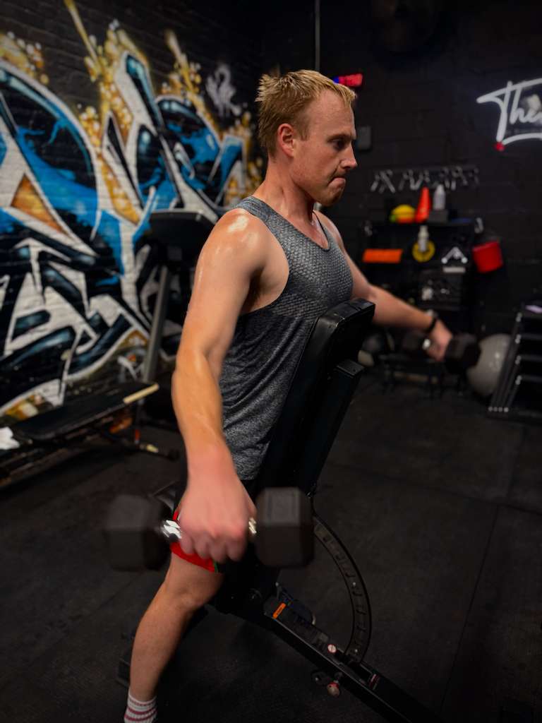 Client doing a single-arm dumbbell row