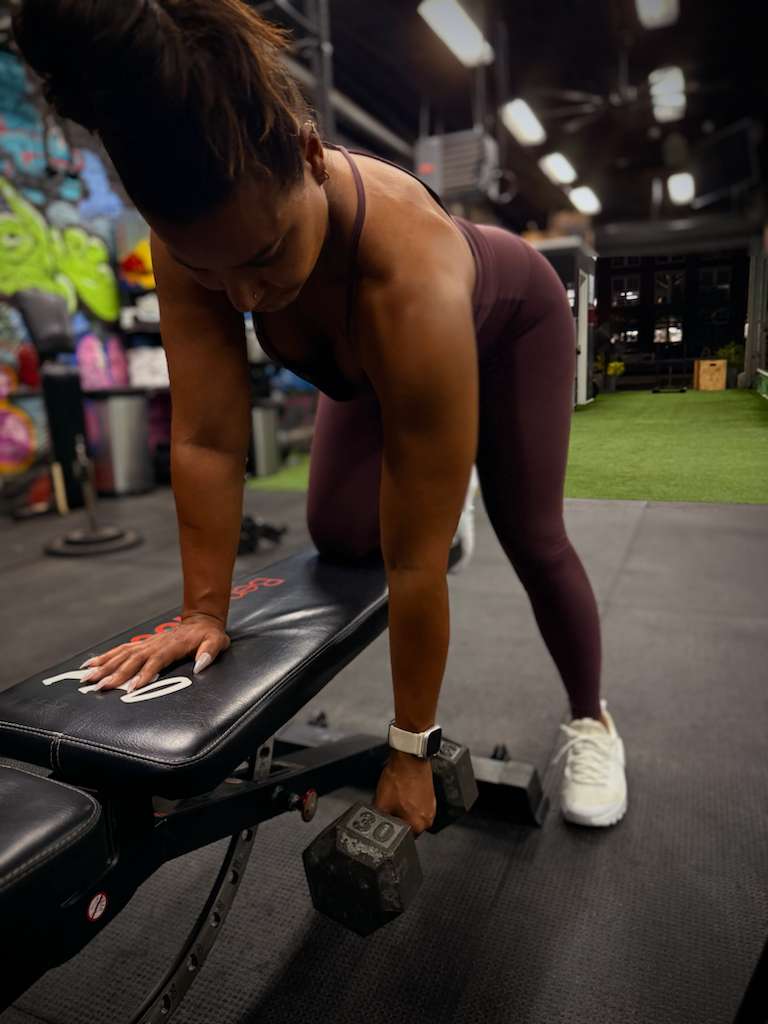 Client doing a bench-supported dumbbell row