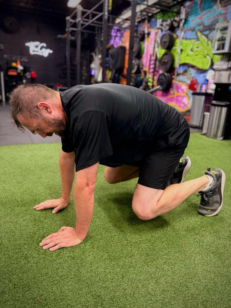 Client doing a bear crawl on the turf