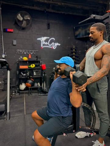 Coach guiding a client through a dumbbell split squat