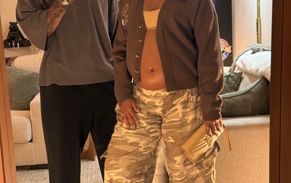 Brandon RaSean and Mariana taking a mirror selfie together, dressed for date night with her baby bump showing.