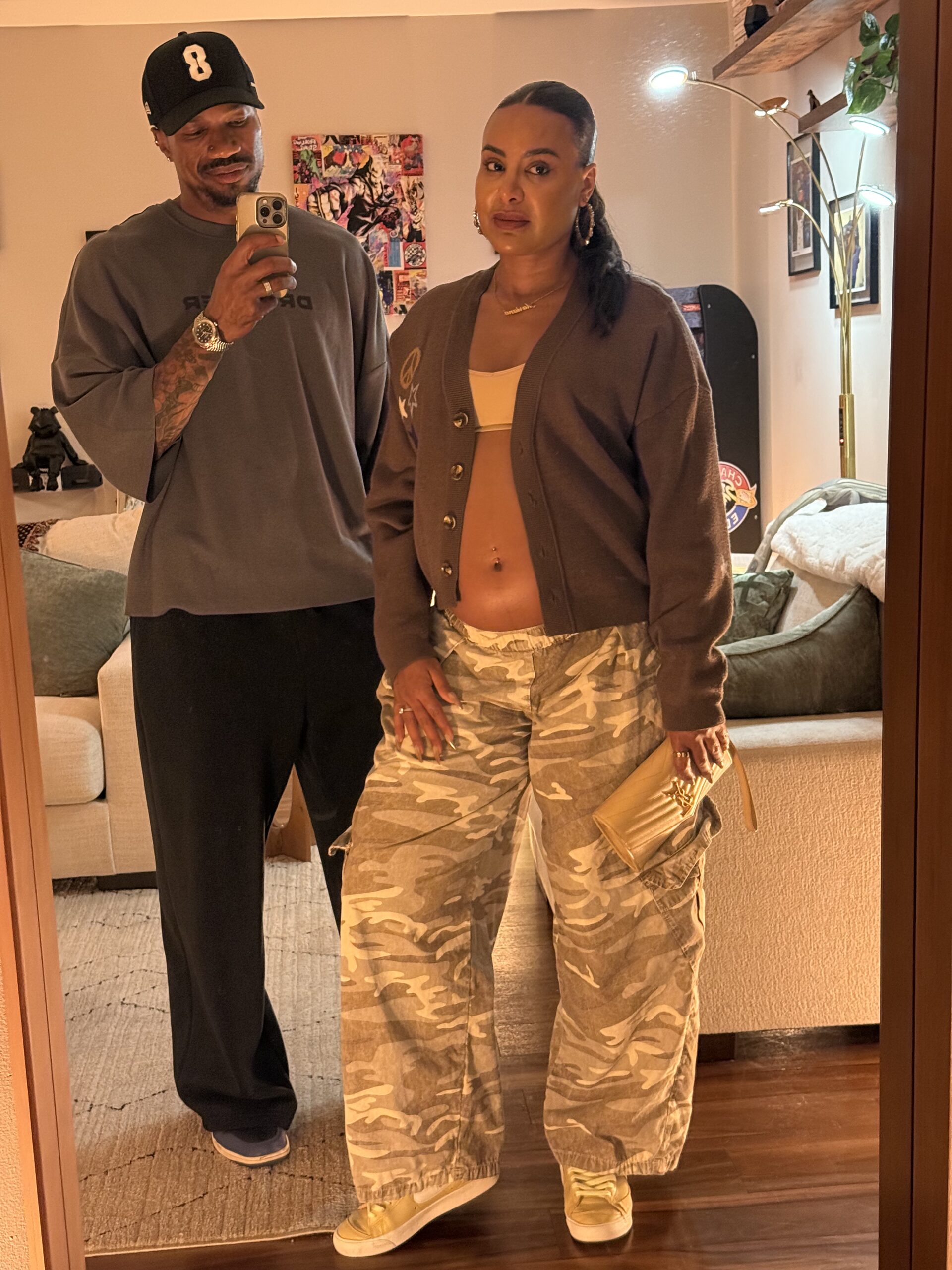 Brandon RaSean and Mariana taking a mirror selfie together, dressed for date night with her baby bump showing.